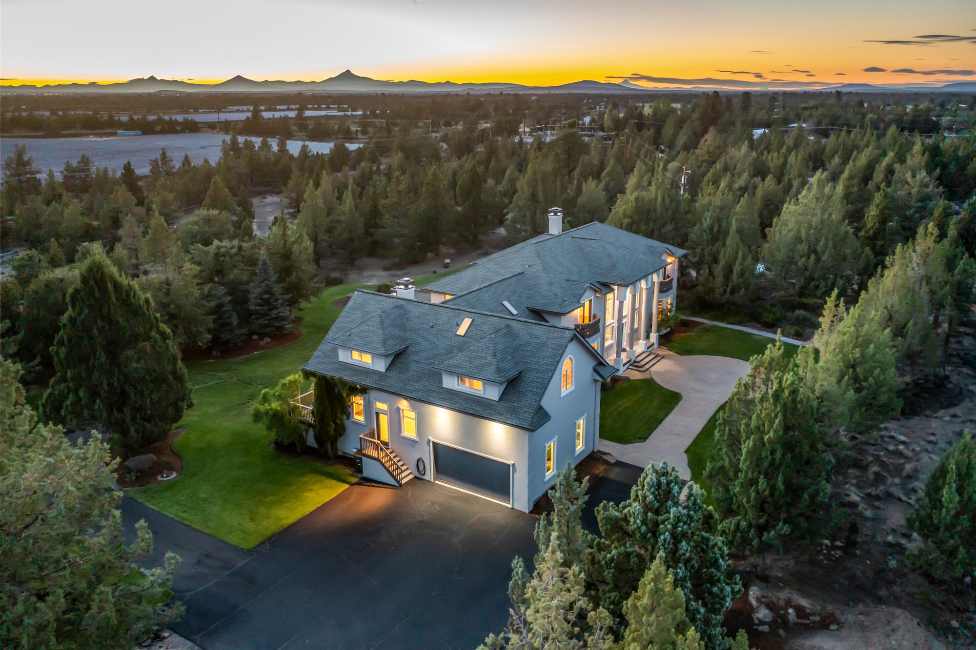 Aerial view of the home with Cascade mountains silhouetted at sunset