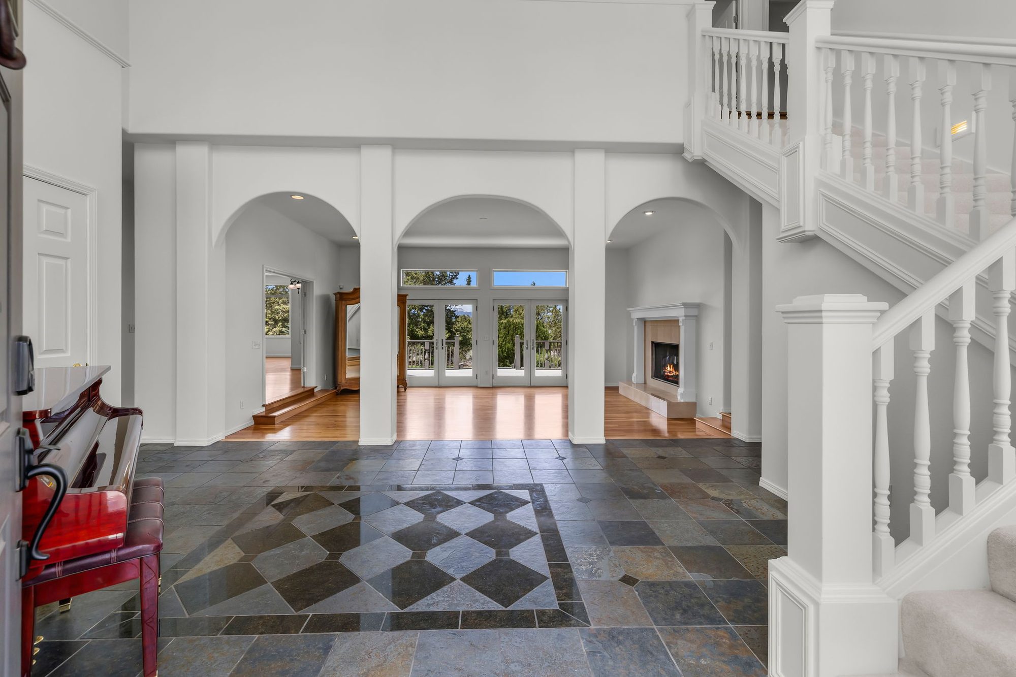 Grand foyer with slate floor and staircase