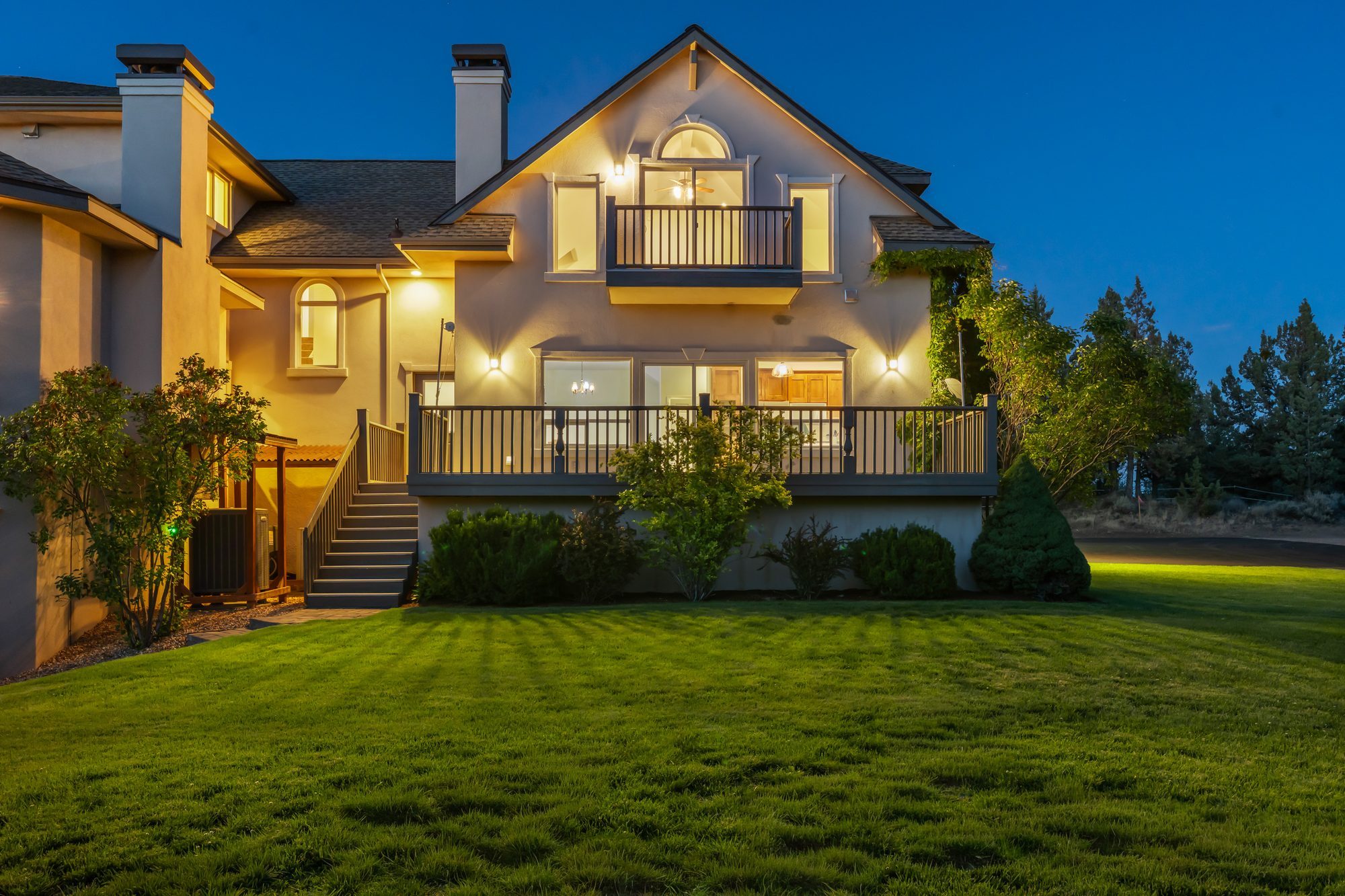 Attached guest house at dusk, with its own deck, balcony, and entrance