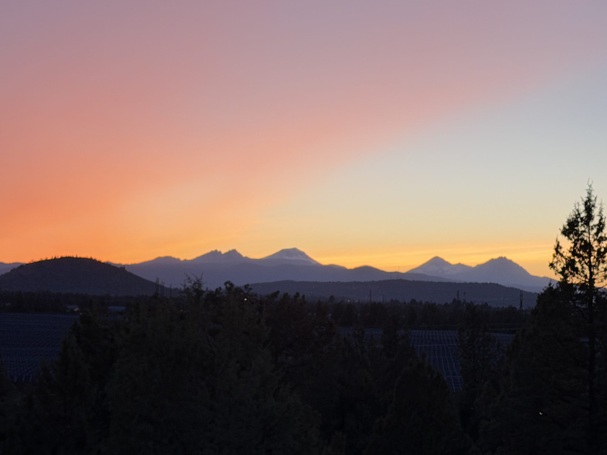 Wide panorama of the Cascade mountain range at sunset from the property